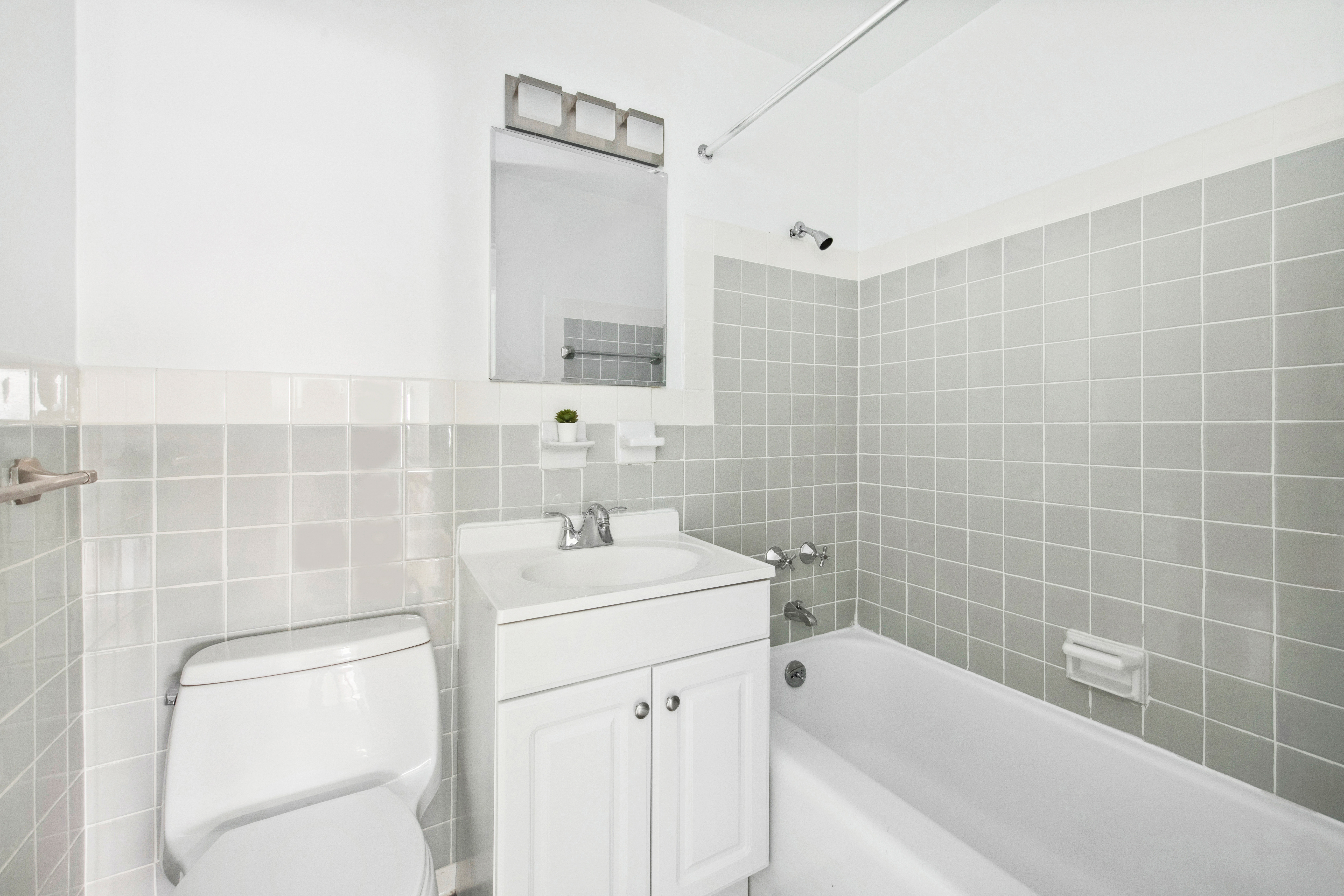 411 East 53rd Street, Unit 20A Manhattan, NY 10022 - Photo 9 of 12 a bathroom with a sink toilet and shower
