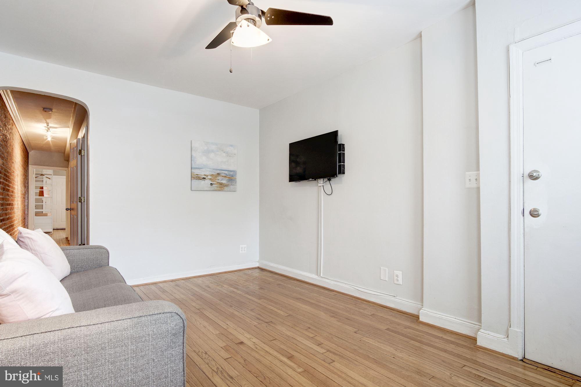 731 13th Street Northeast Washington, DC 20002 - Photo 27 of 43 a living room with furniture and a flat screen tv