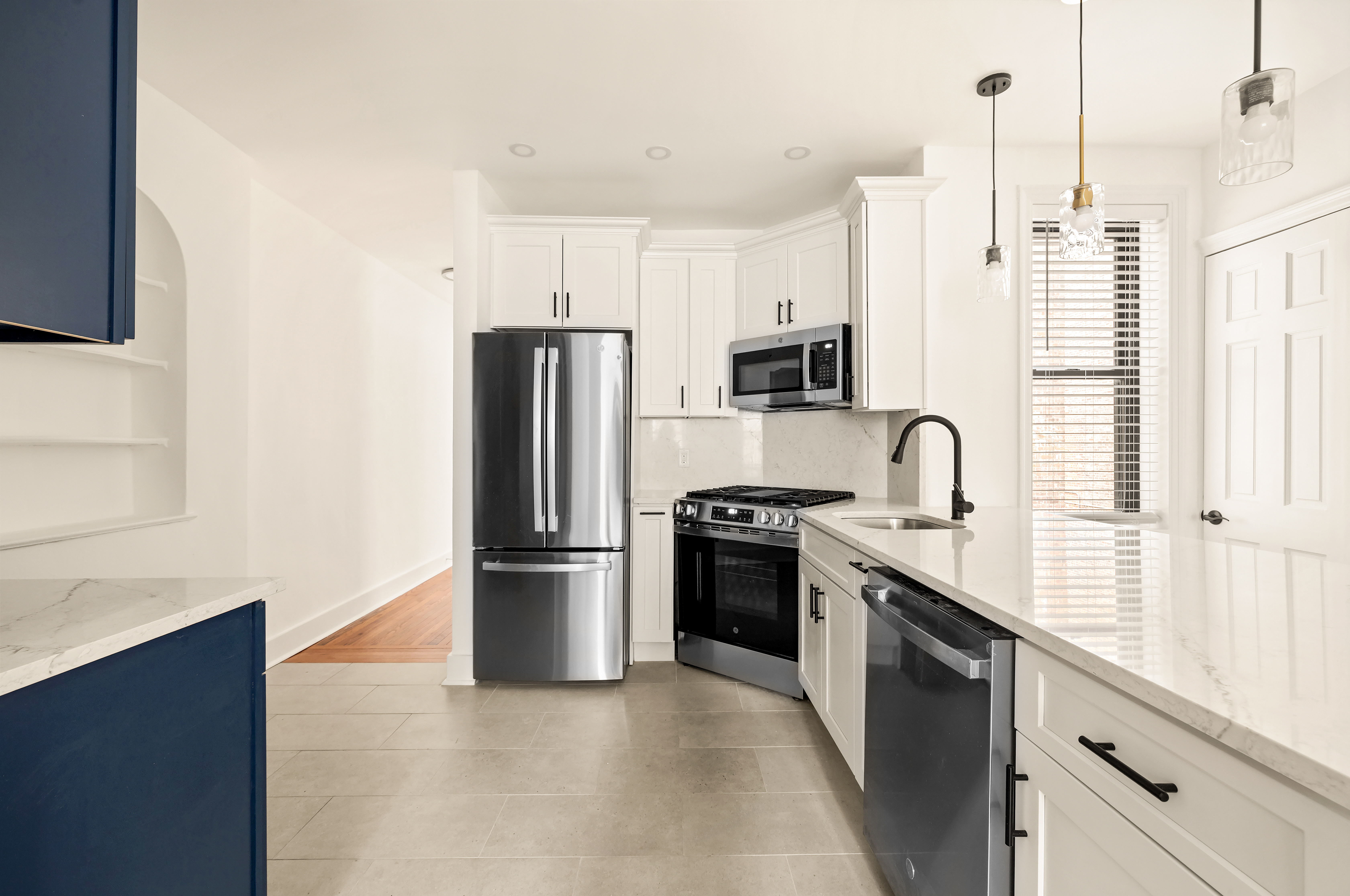 a kitchen with stainless steel appliances granite countertop a refrigerator a stove and a sink