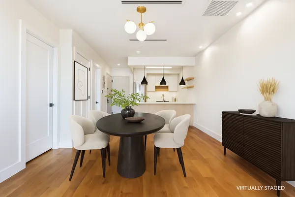 a view of a dining room with furniture and wooden floor