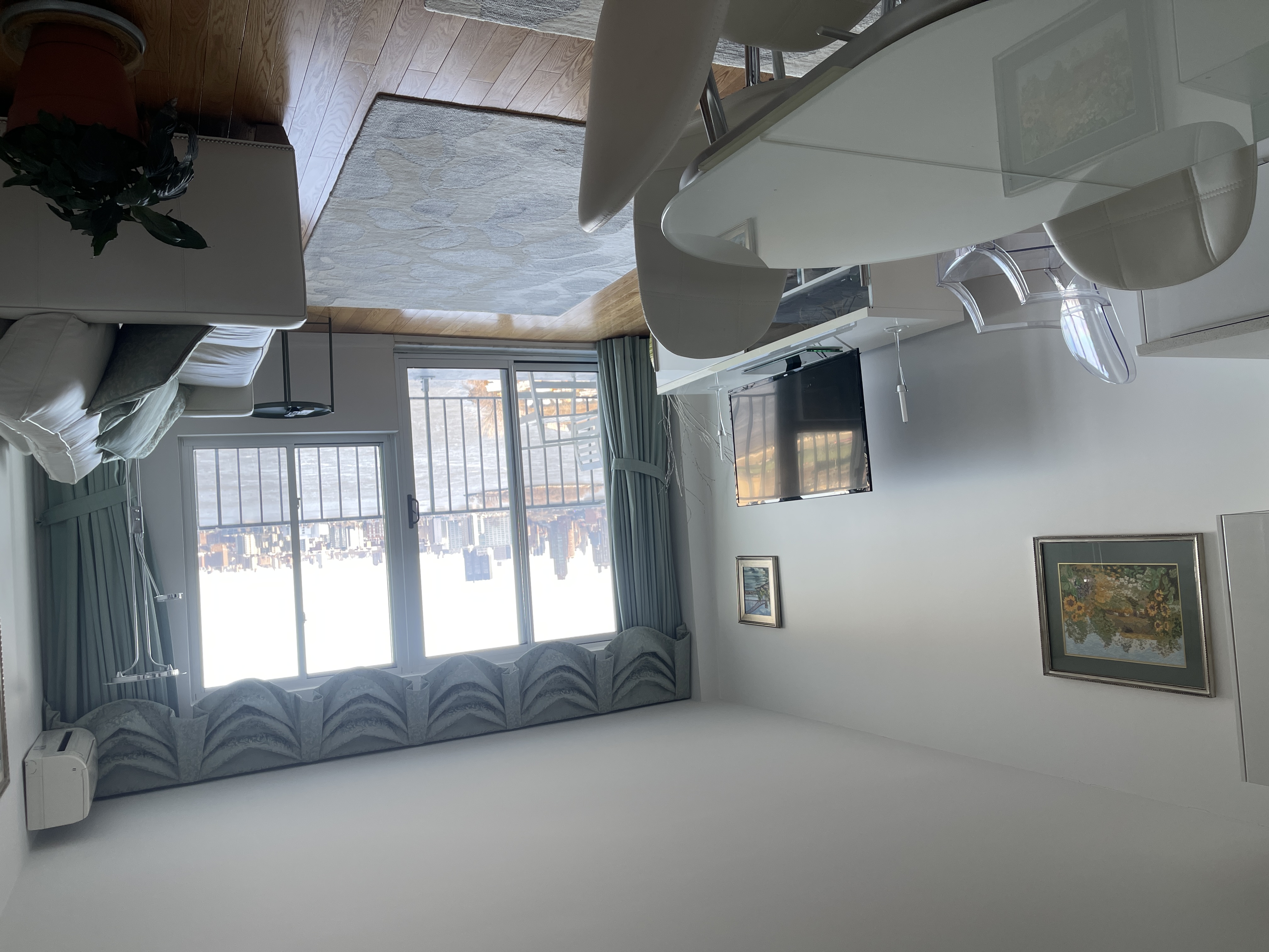 25-40 Shore Boulevard, Unit 15T Queens, NY 11102 - Photo 2 of 22 a living room with furniture and a flat screen tv