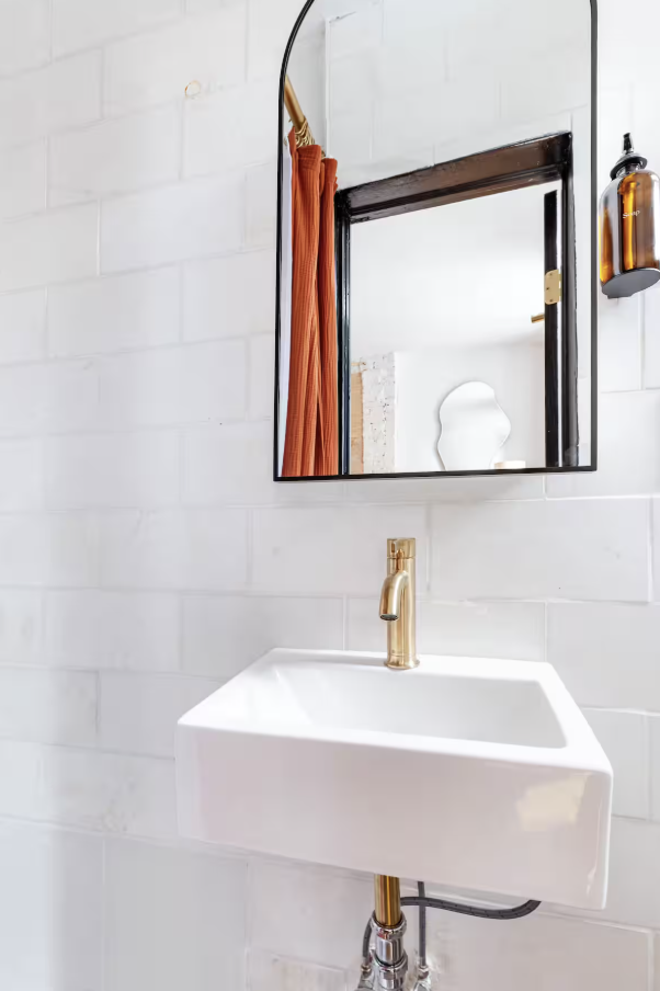 240 Mulberry Street, Unit 2 Manhattan, NY 10012 - Photo 17 of 19 a bathroom with a sink and a mirror