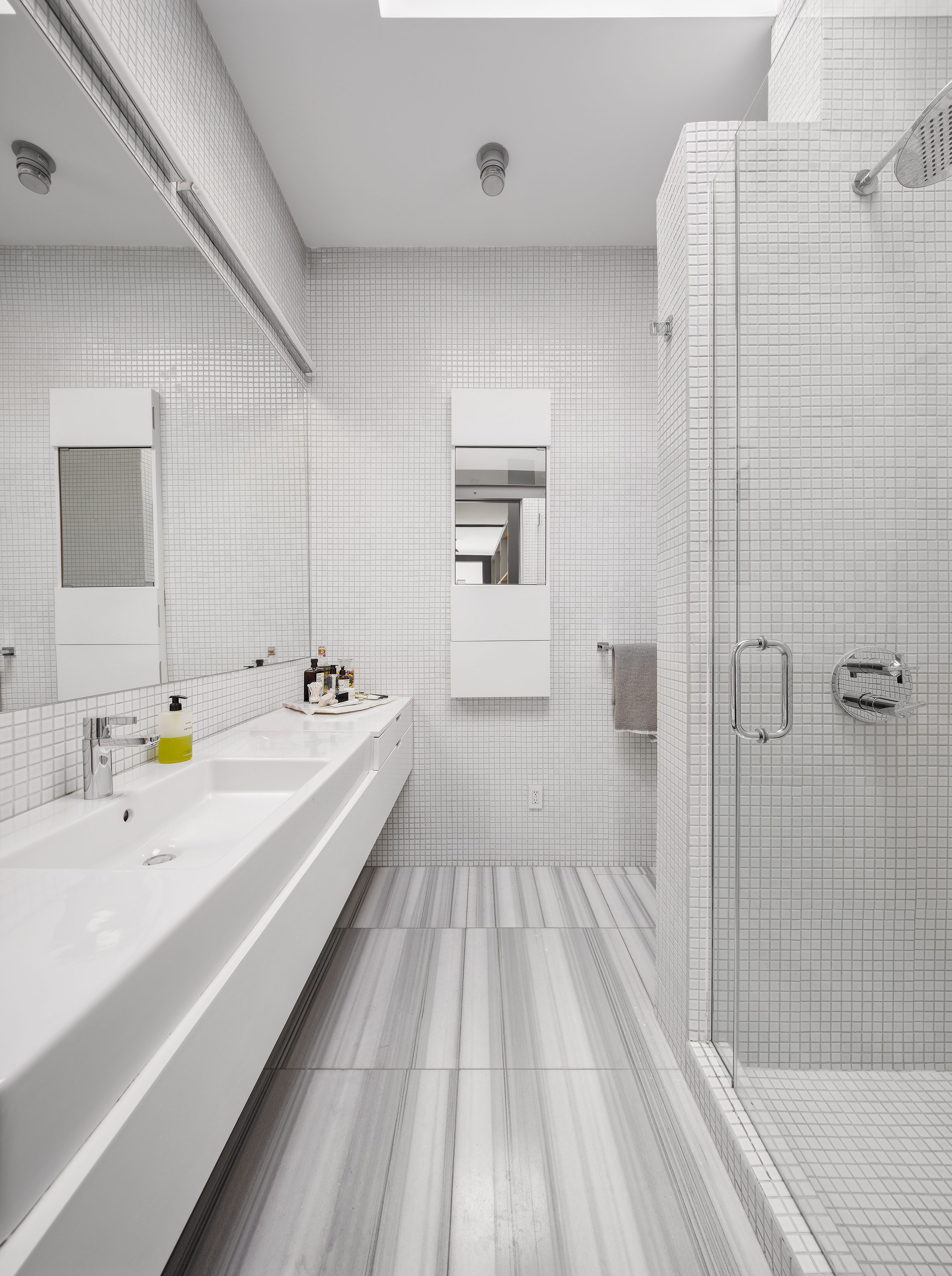 281 West 11th Street, Unit 4/5C Manhattan, NY 10014 - Photo 16 of 18 a spacious bathroom with a double vanity sink and mirror