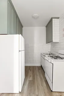 a kitchen with a stove a refrigerator and a sink