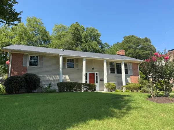 a front view of house with yard and green space
