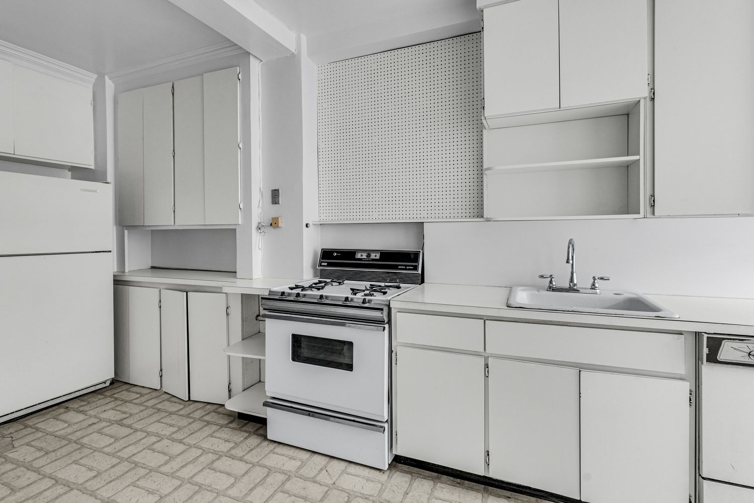 473 West End Avenue, Unit 12A Manhattan, NY 10024 - Photo 8 of 21 a kitchen with white cabinets and white appliances