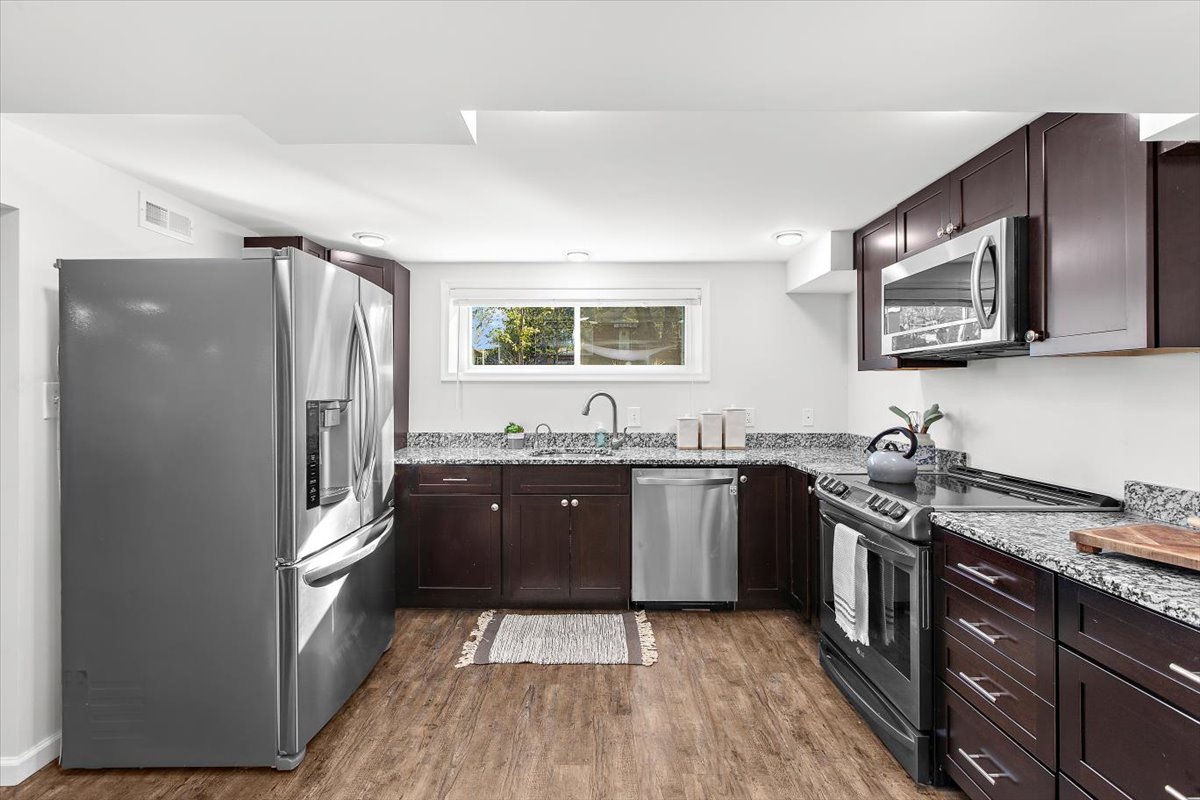 12712 Atherton Drive Silver Spring, MD 20906 - Photo 21 of 40 a kitchen with stainless steel appliances granite countertop a refrigerator stove and sink