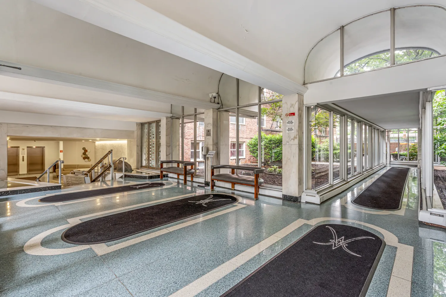 a view of pathway with building and trees