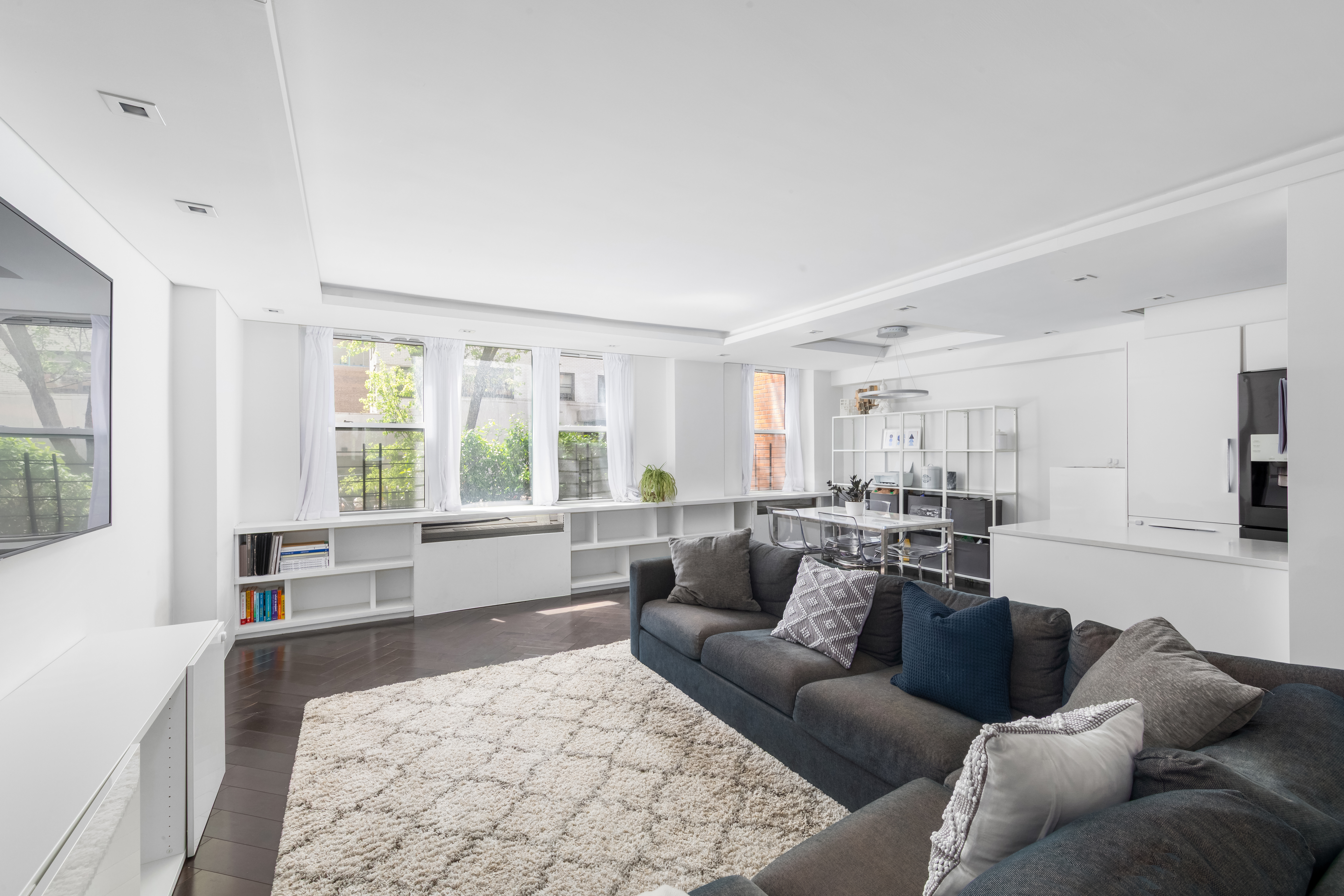207 East 74th Street, Unit 1J Manhattan, NY 10021 - Photo 2 of 9 a living room with furniture and a large window