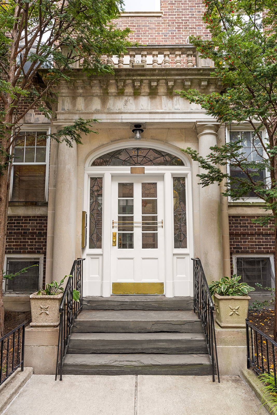 34-27 79th Street, Unit 42 Queens, NY 11372 - Photo 14 of 15 a front view of a house with a garden