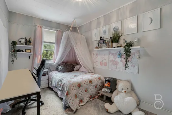 a bedroom with a bed and a table