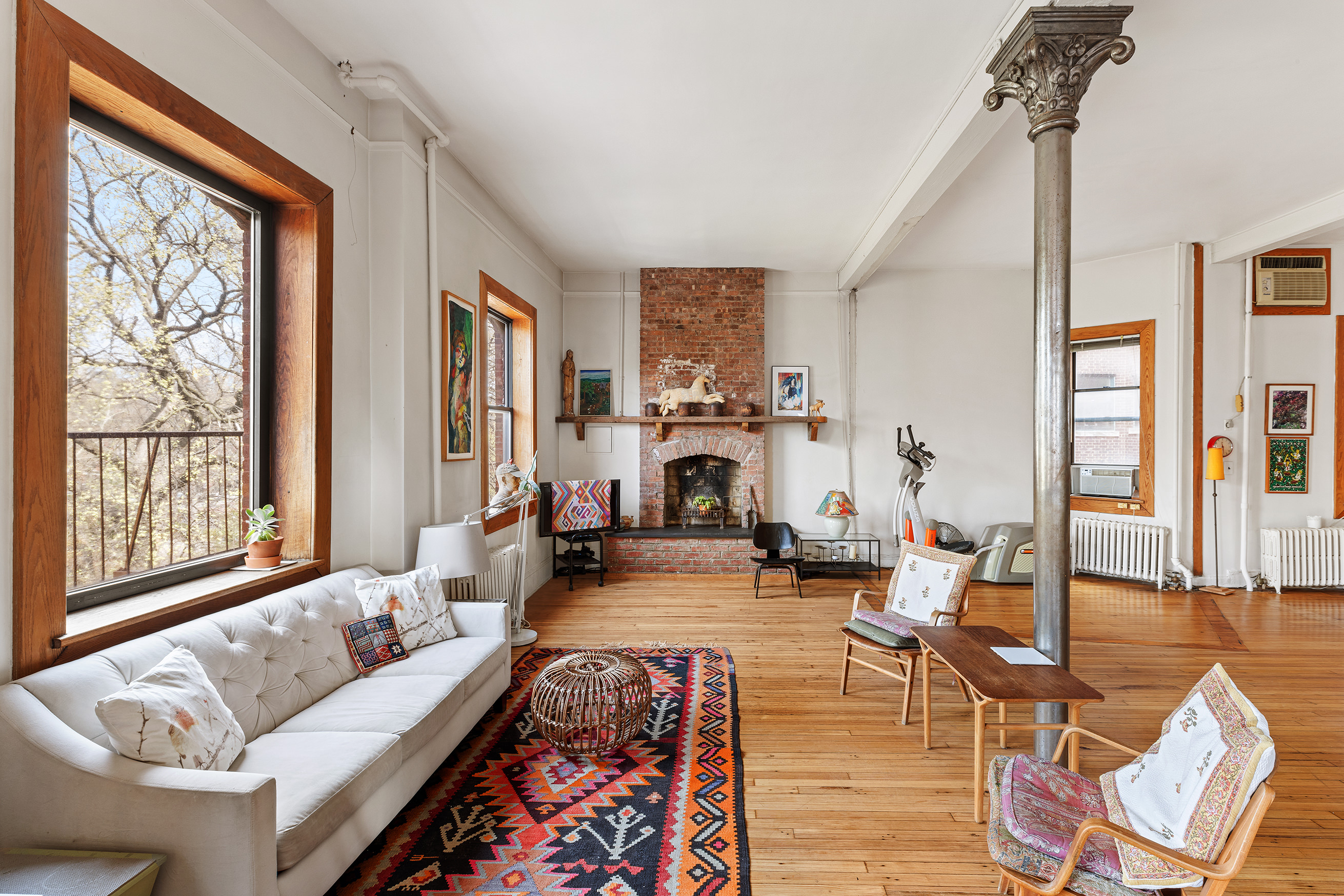 295 East 8th Street, Unit 3W Manhattan, NY 10009 - Photo 4 of 18 a living room with furniture large window and wooden floor