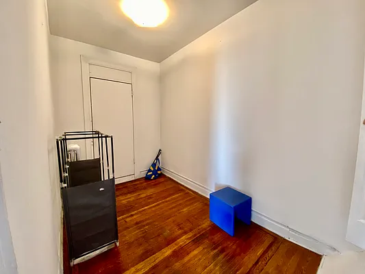 6825 7th Avenue, Unit 2 Brooklyn, NY 11220 - Photo 7 of 9 an empty room with wooden floor