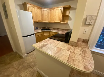 a kitchen with a refrigerator and a stove
