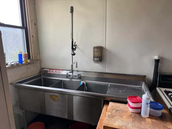 a kitchen with a sink and cabinets