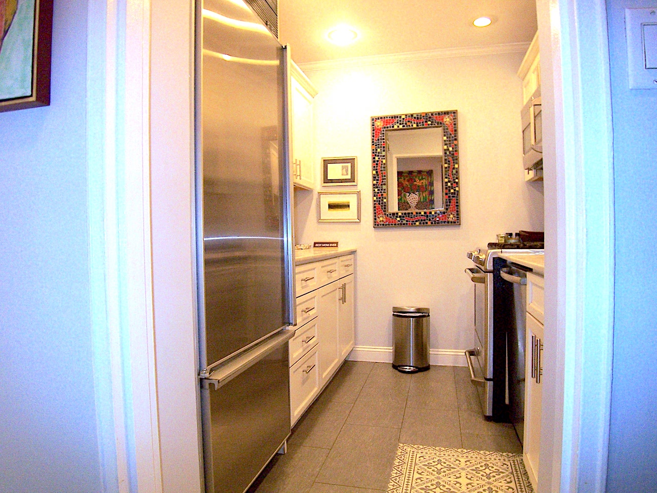 136 East 76th Street, Unit 3E Manhattan, NY 10021 - Photo 7 of 11 a kitchen with a refrigerator and cabinets