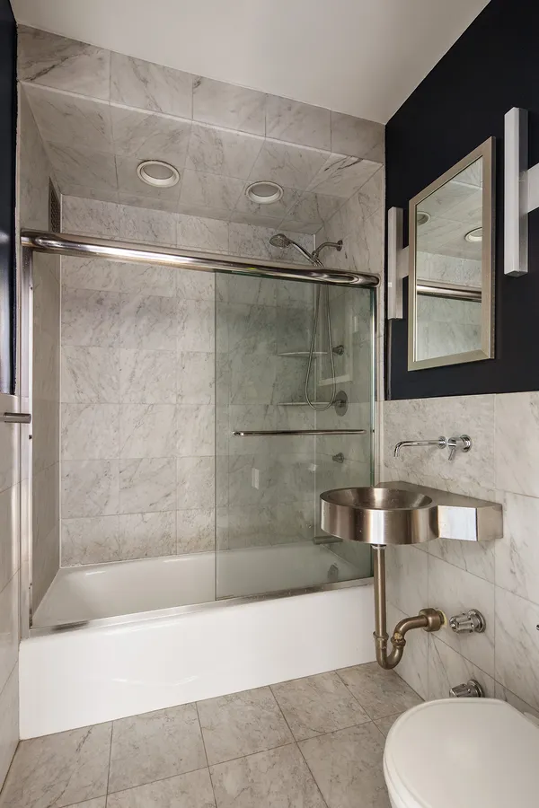 a bathroom with a bathtub and shower