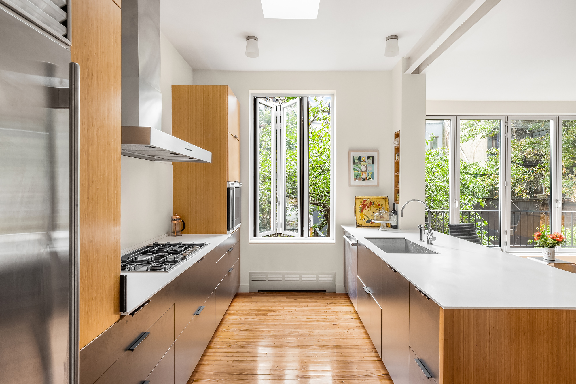 128 State Street, Unit 2 Brooklyn, NY 11201 - Photo 4 of 15 a large white room with a large window and a table