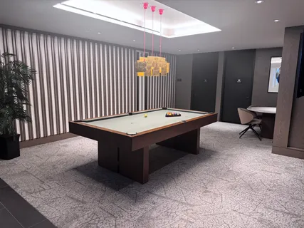 a room with pool table and glass door