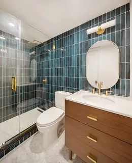 a bathroom with a sink mirror vanity and toilet