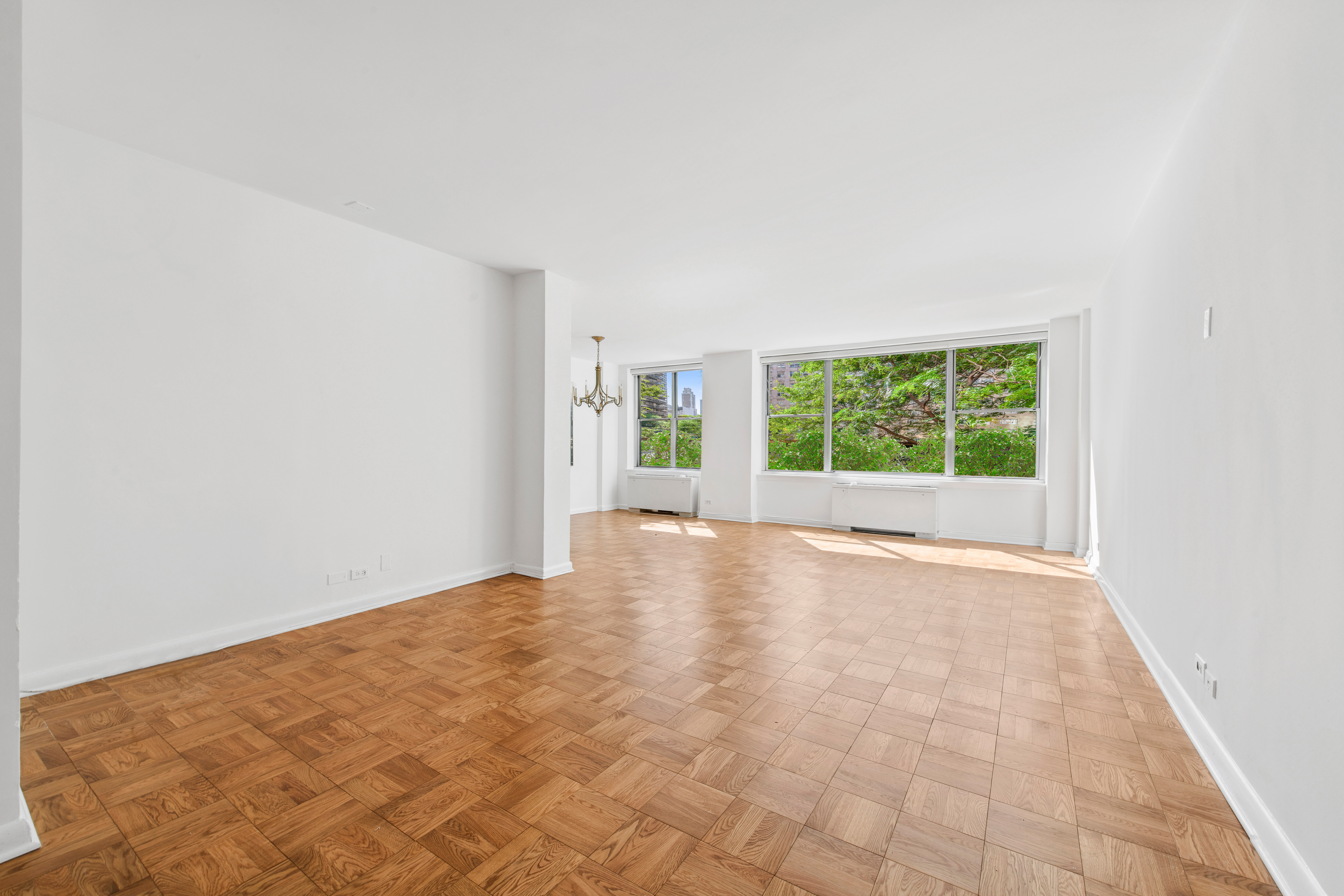 201 East 62nd Street, Unit 2C Manhattan, NY 10065 - Photo 2 of 14 an empty room with windows