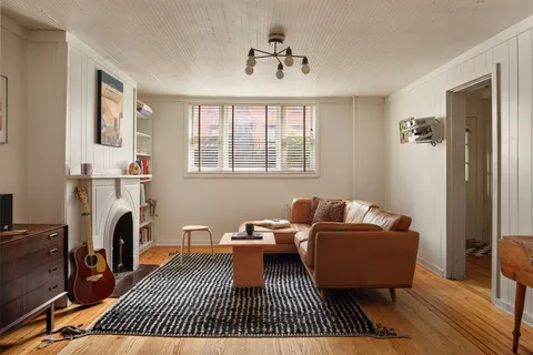a living room with furniture a window and a rug