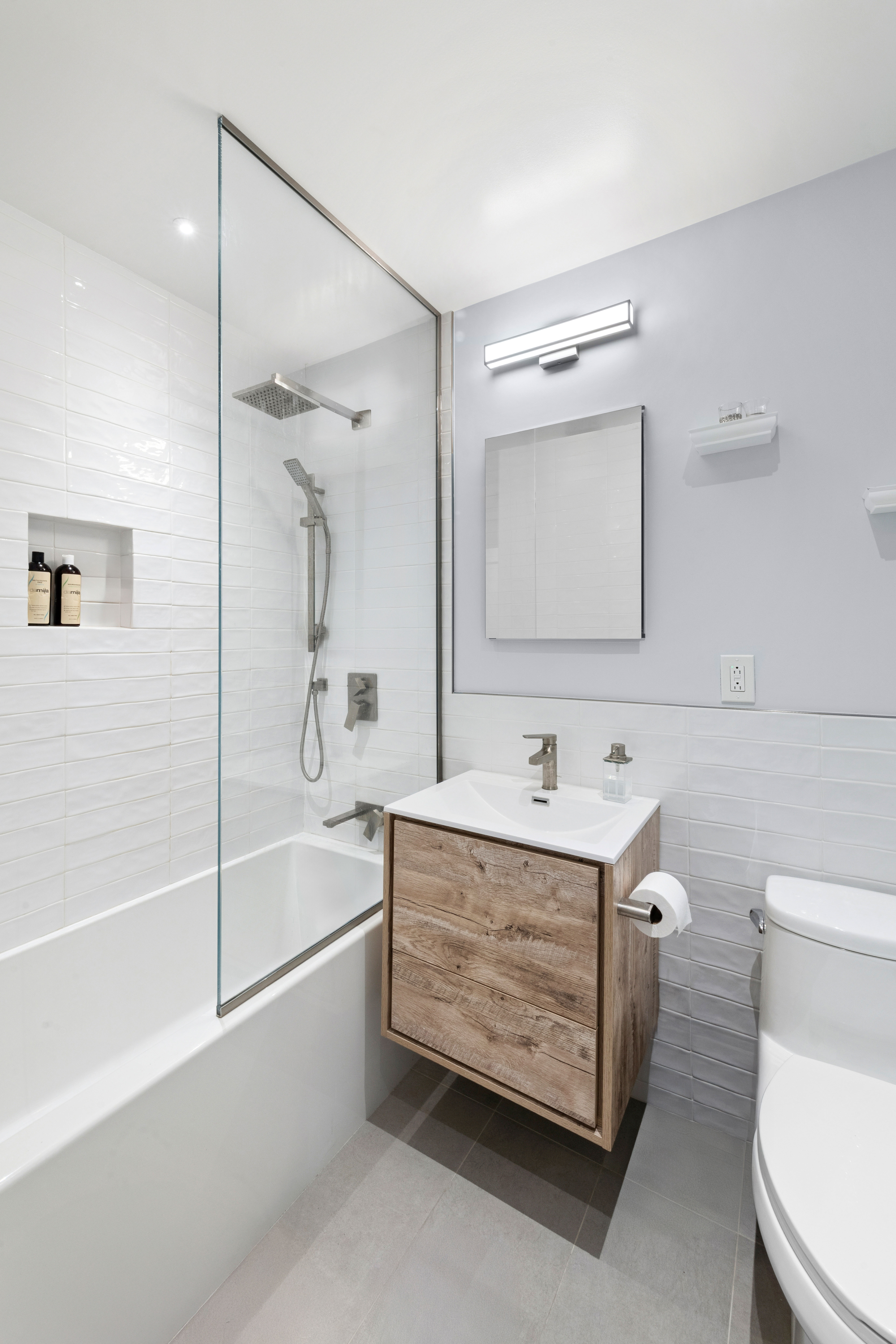 400 East 56th Street, Unit 19O Manhattan, NY 10022 - Photo 11 of 20 a bathroom with a sink a toilet and shower