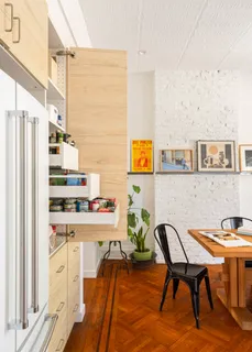 a view of a workspace with furniture and a kitchen