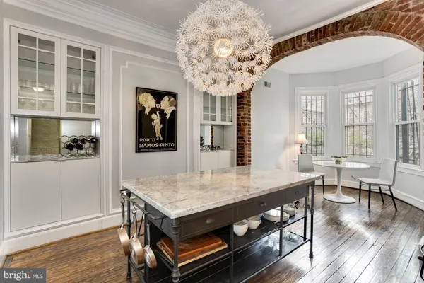 a dining room with furniture and wooden floor