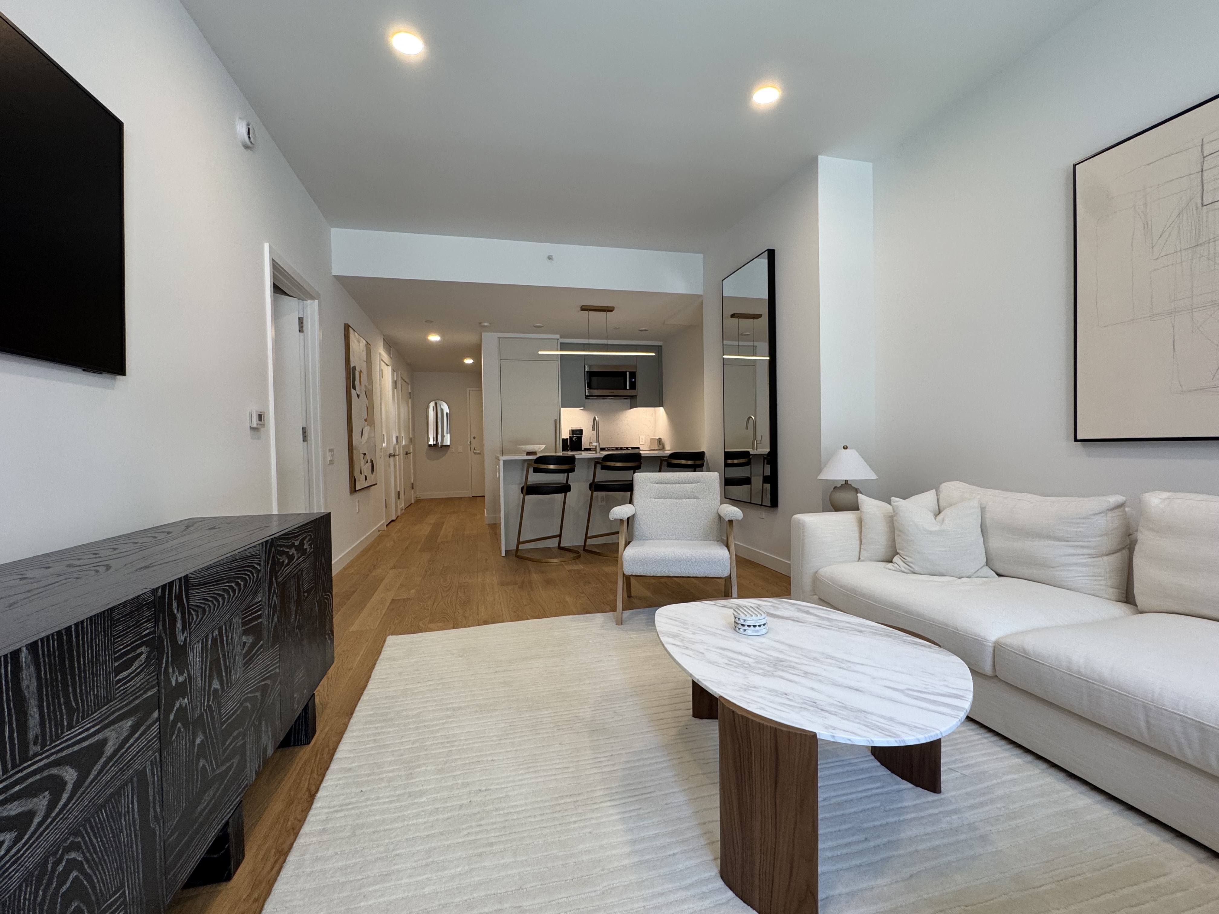 18 West 55th Street, Unit 7B Manhattan, NY 10019 - Photo 7 of 20 a living room with furniture and a wooden floor