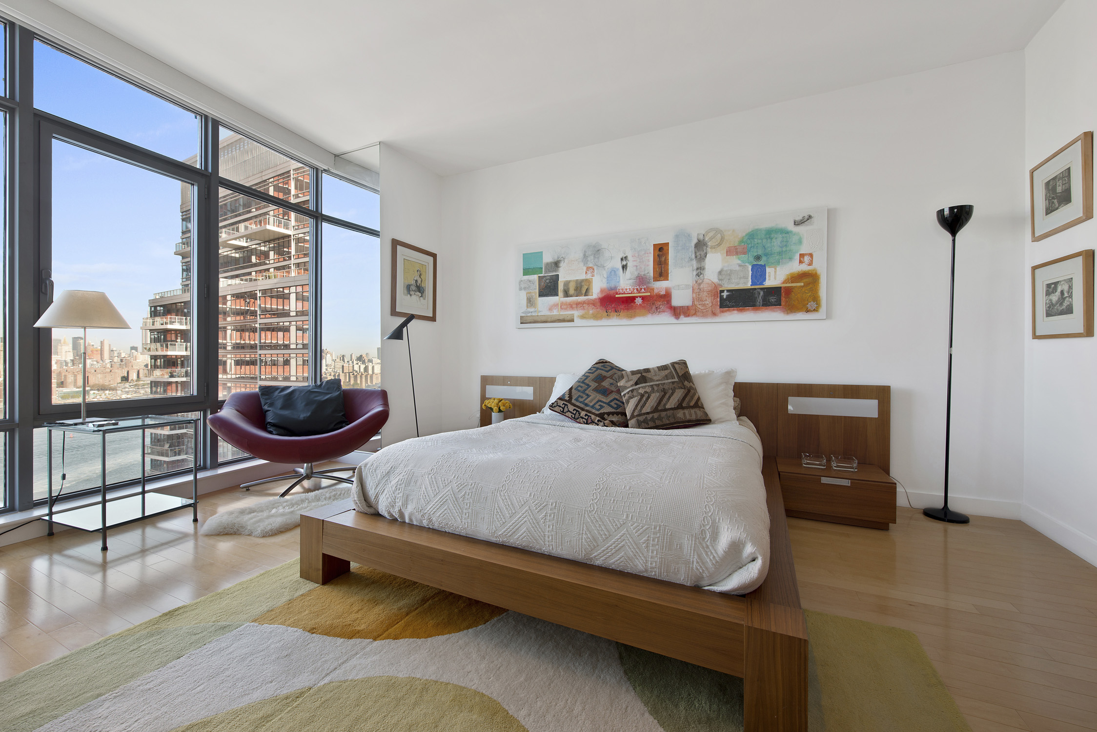 1 Northside Piers, Unit 25D Brooklyn, NY 11249 - Photo 7 of 19 a bedroom with a bed a bookshelf and a large window