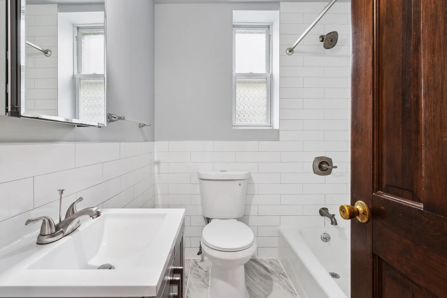 a bathroom with a sink a toilet and a mirror