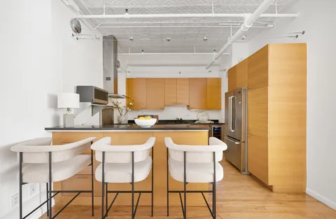 a dining table seating next to a window