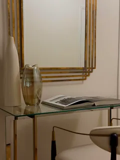 a bedroom with a bed and a lamp on dresser