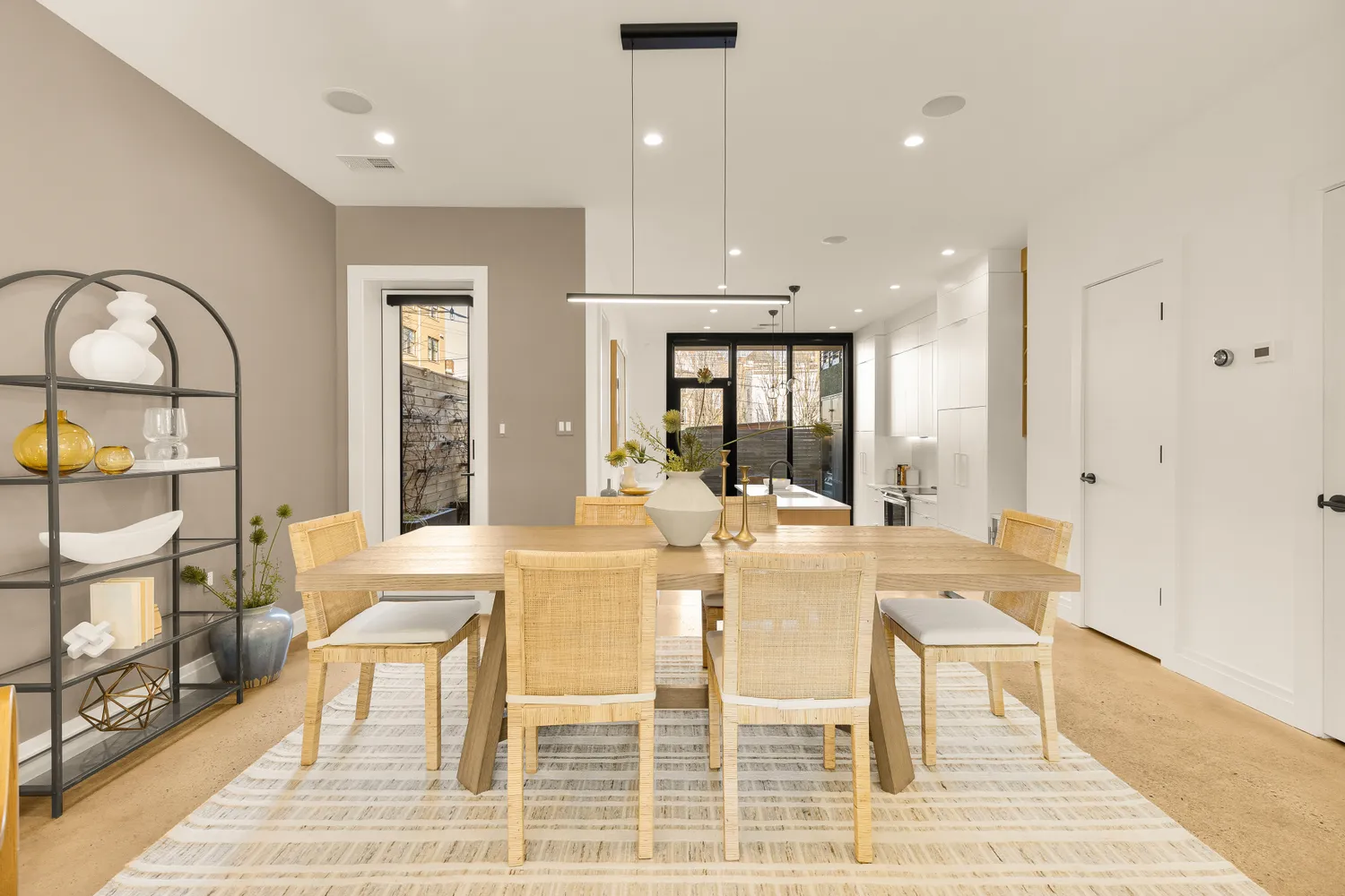 a view of a dining room with furniture a rug and wooden floor