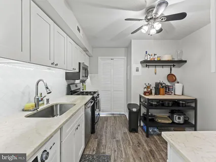a kitchen with cabinets appliances and a sink