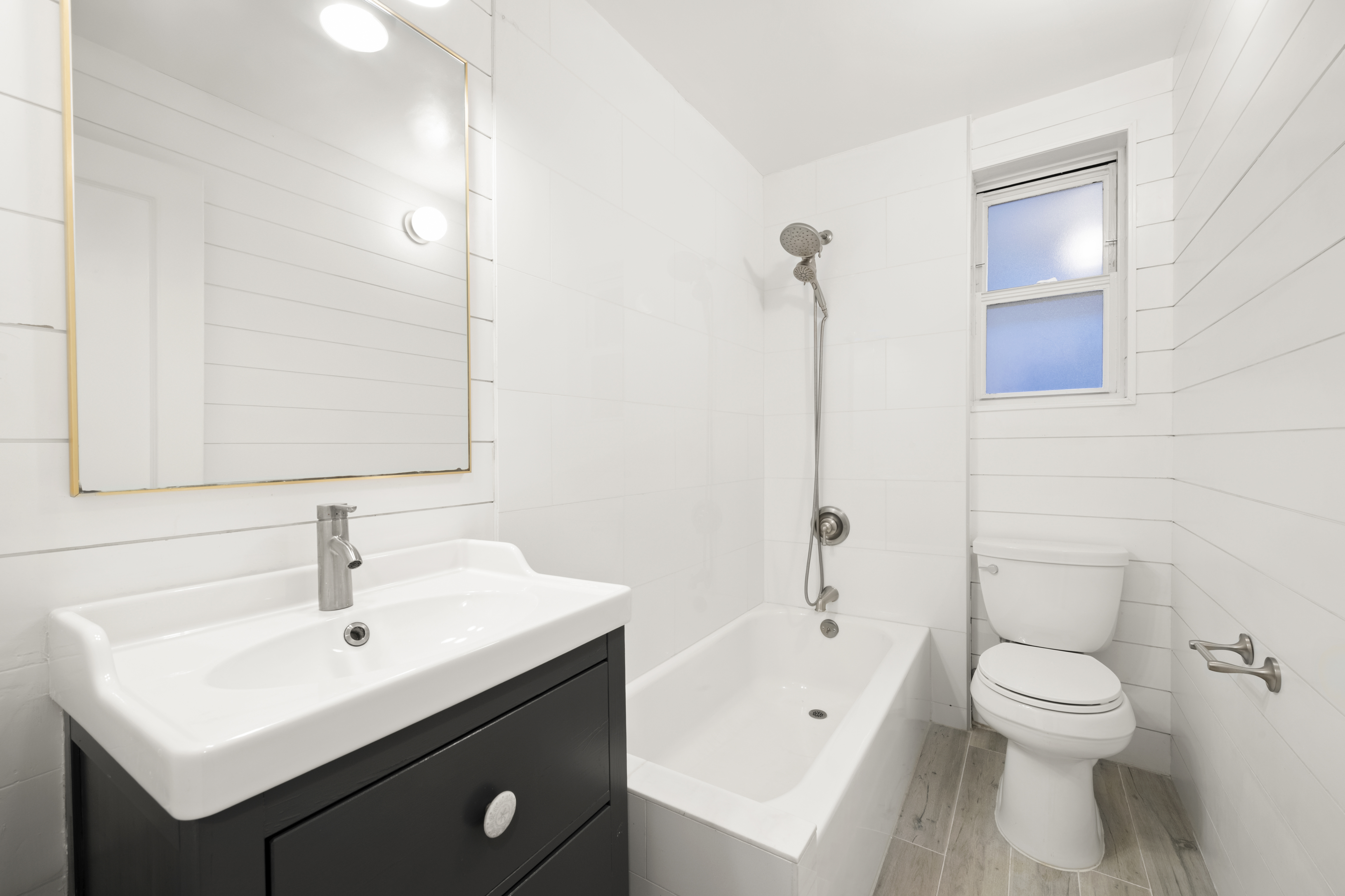 152 East 94th Street, Unit 2J Manhattan, NY 10128 - Photo 15 of 18 a bathroom with a sink a toilet and shower