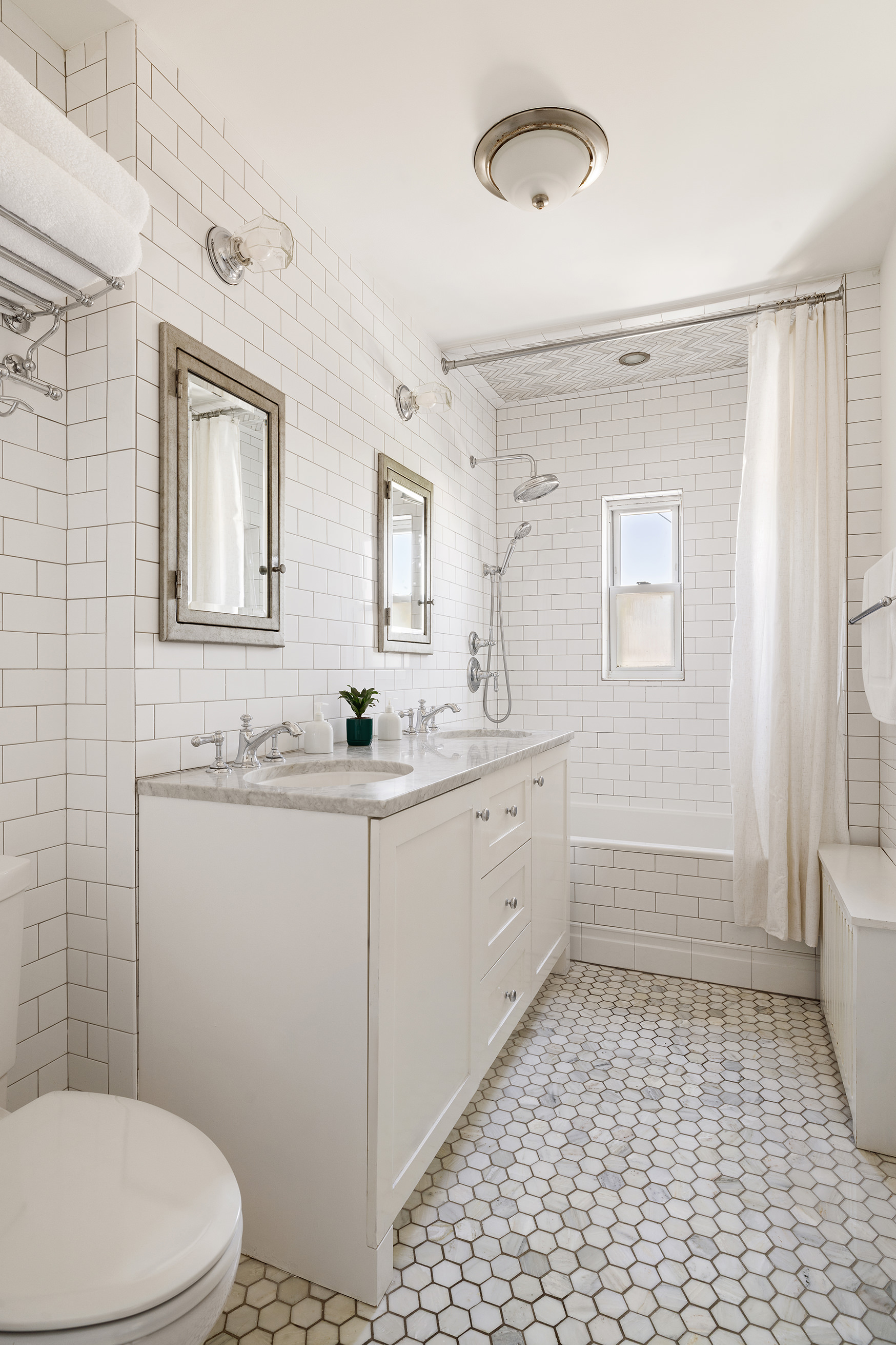 17-05 Willoughby Avenue Queens, NY 11385 - Photo 6 of 13 a bathroom with a sink a toilet and shower
