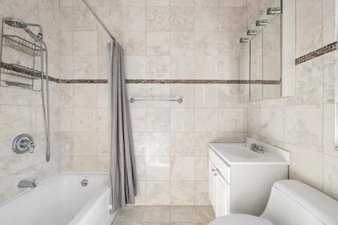 a bathroom with a bathtub and shower
