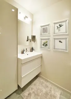 a bathroom with a sink mirror and vanity