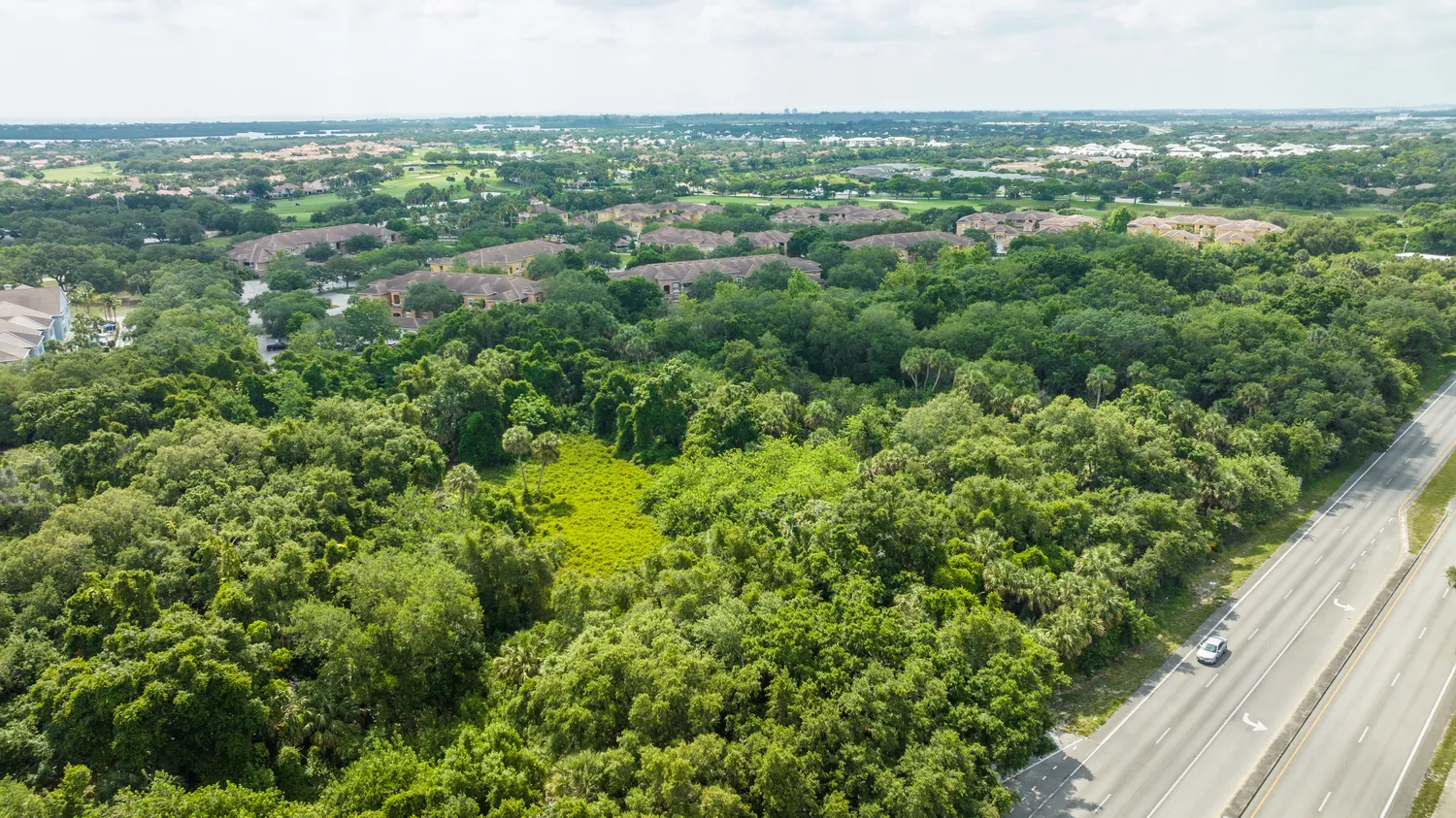 an aerial view of residential houses with city view