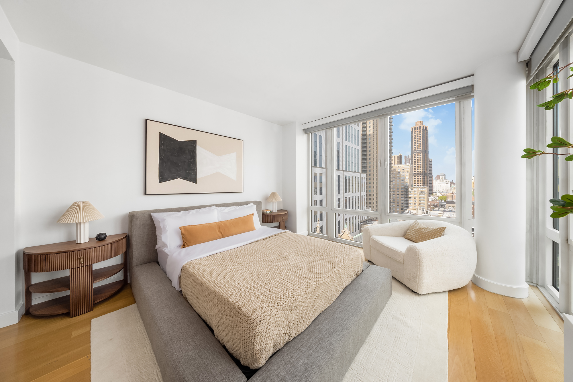 408 East 79th Street, Unit 14B Manhattan, NY 10075 - Photo 12 of 18 a bedroom with a bed and wooden floor