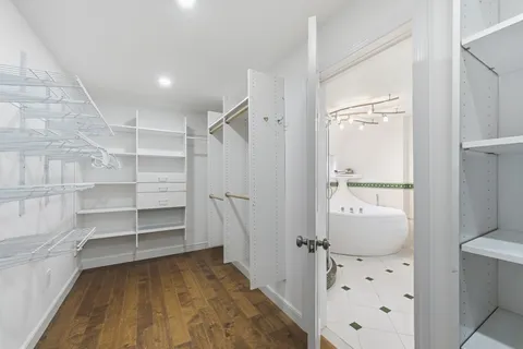 a bedroom with two beds and painting on the wall