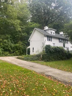 a front view of a house with yard and green space