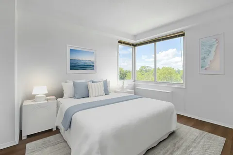 a bedroom with a large bed and a window