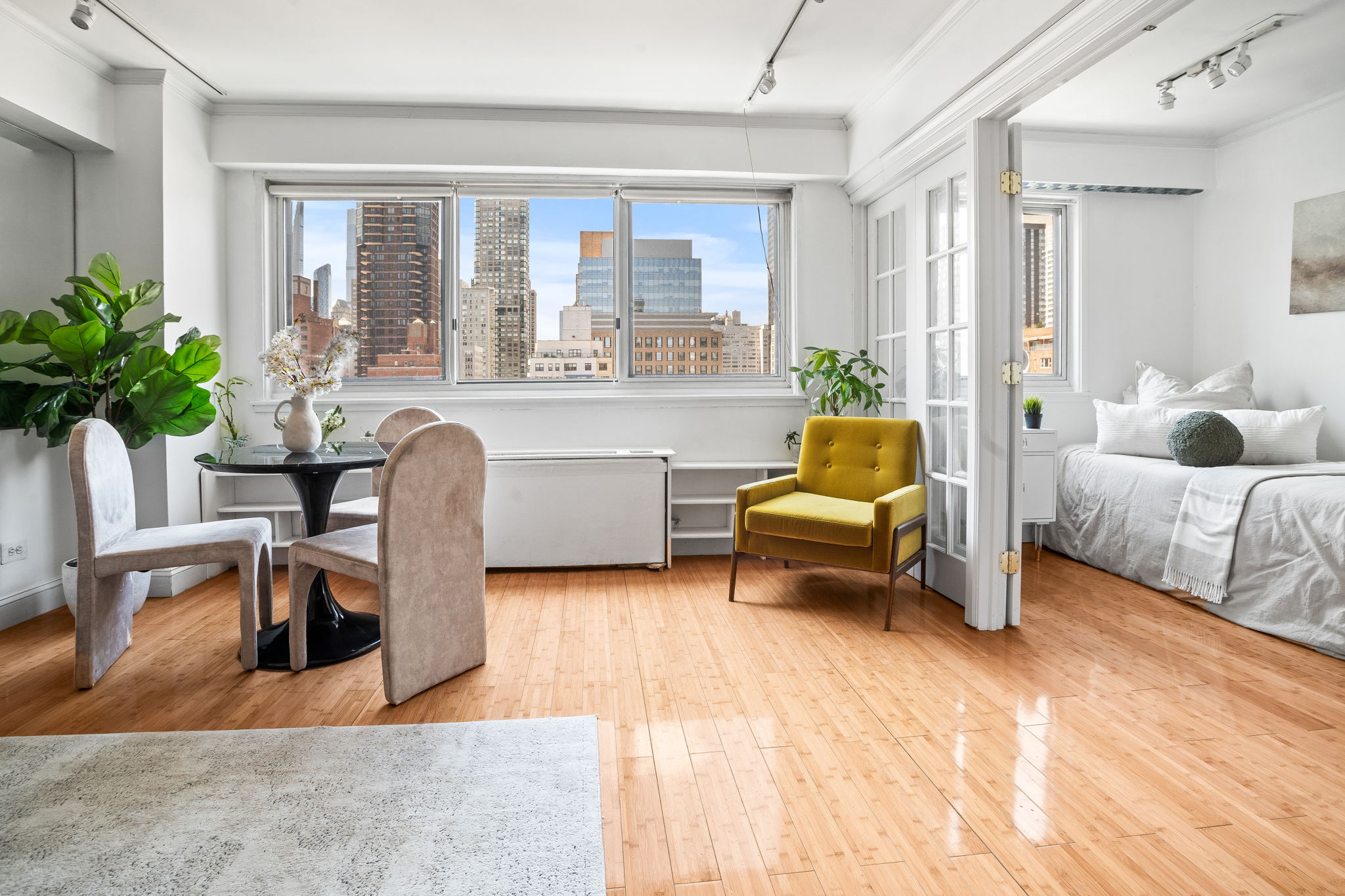 401 East 65th Street, Unit 12F Manhattan, NY 10065 - Photo 3 of 18 a living room with furniture and large windows