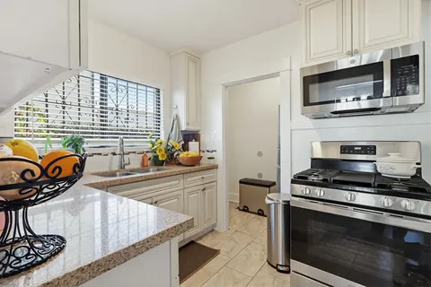 a kitchen with stainless steel appliances a stove a microwave and cabinets