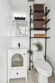 a bathroom with a toilet a sink and a window