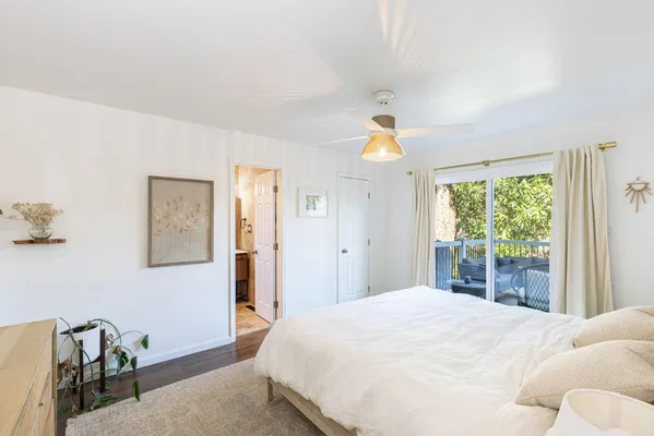 a bedroom with a large bed and a window
