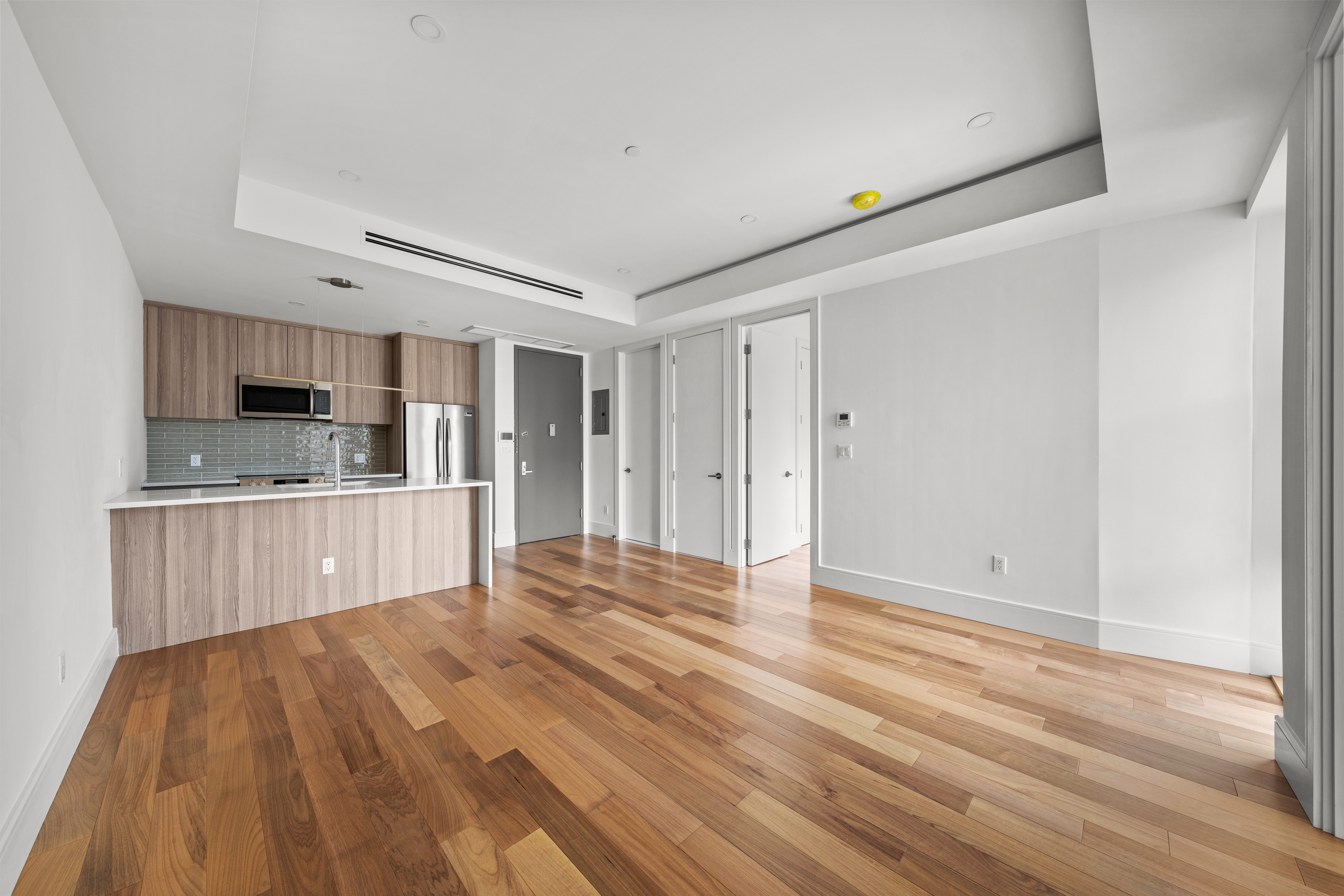 82 Cooper Street, Unit 2B Brooklyn, NY 11207 - Photo 14 of 17 a view of kitchen with granite countertop cabinets and wooden floor